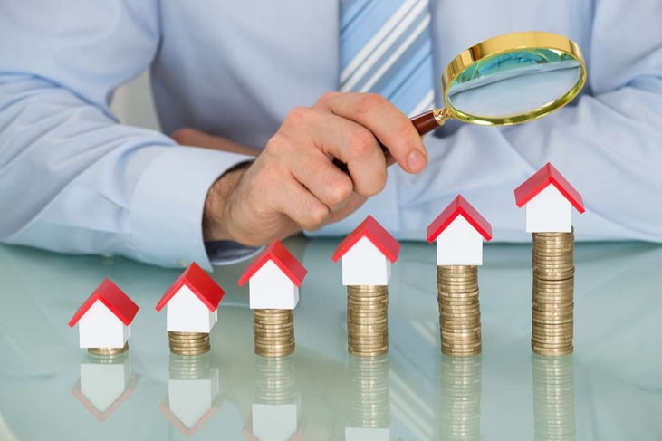 Businessman with Magnifying Glass and Coins