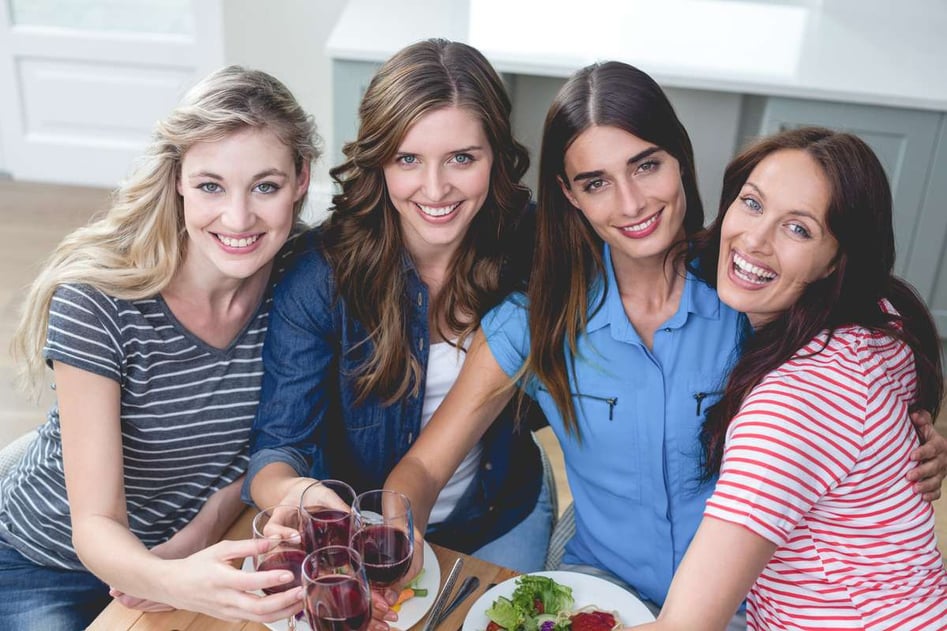 Friends holding glasses of red wine