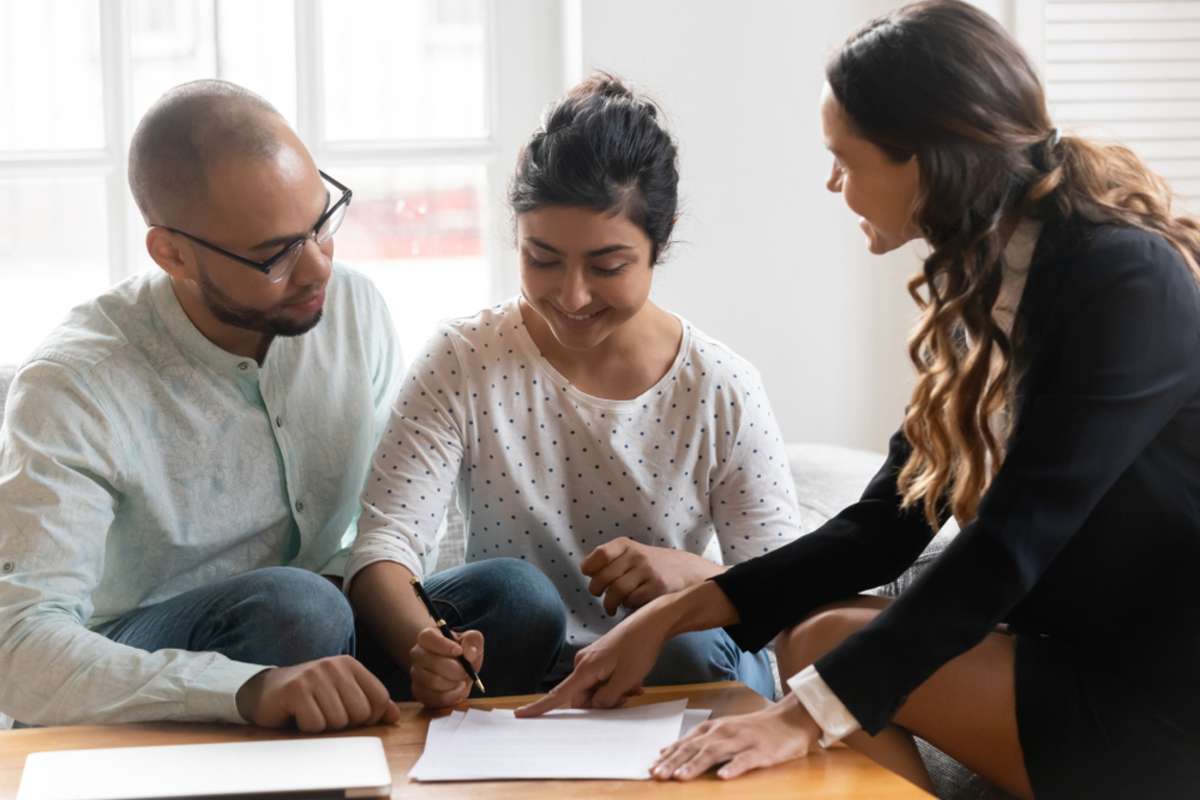 Happy diverse couple satisfied clients making deal