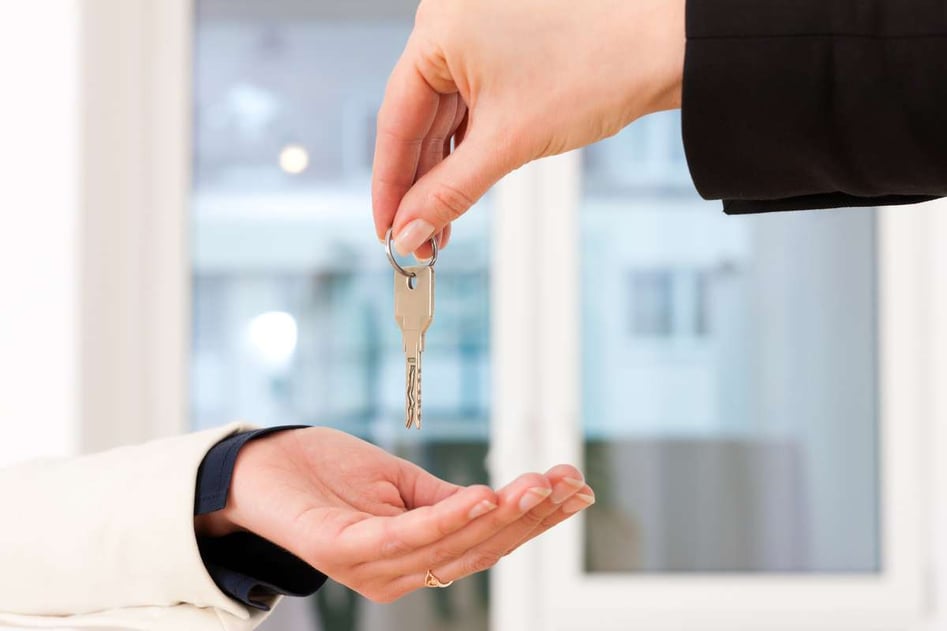 Young realtor is with keys in an apartment