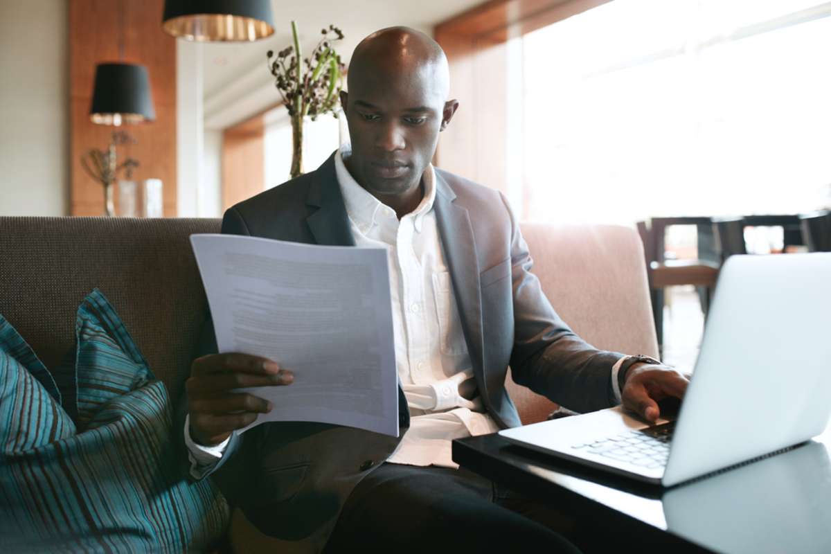 businessman sitting a hotel coffee shop reading a document