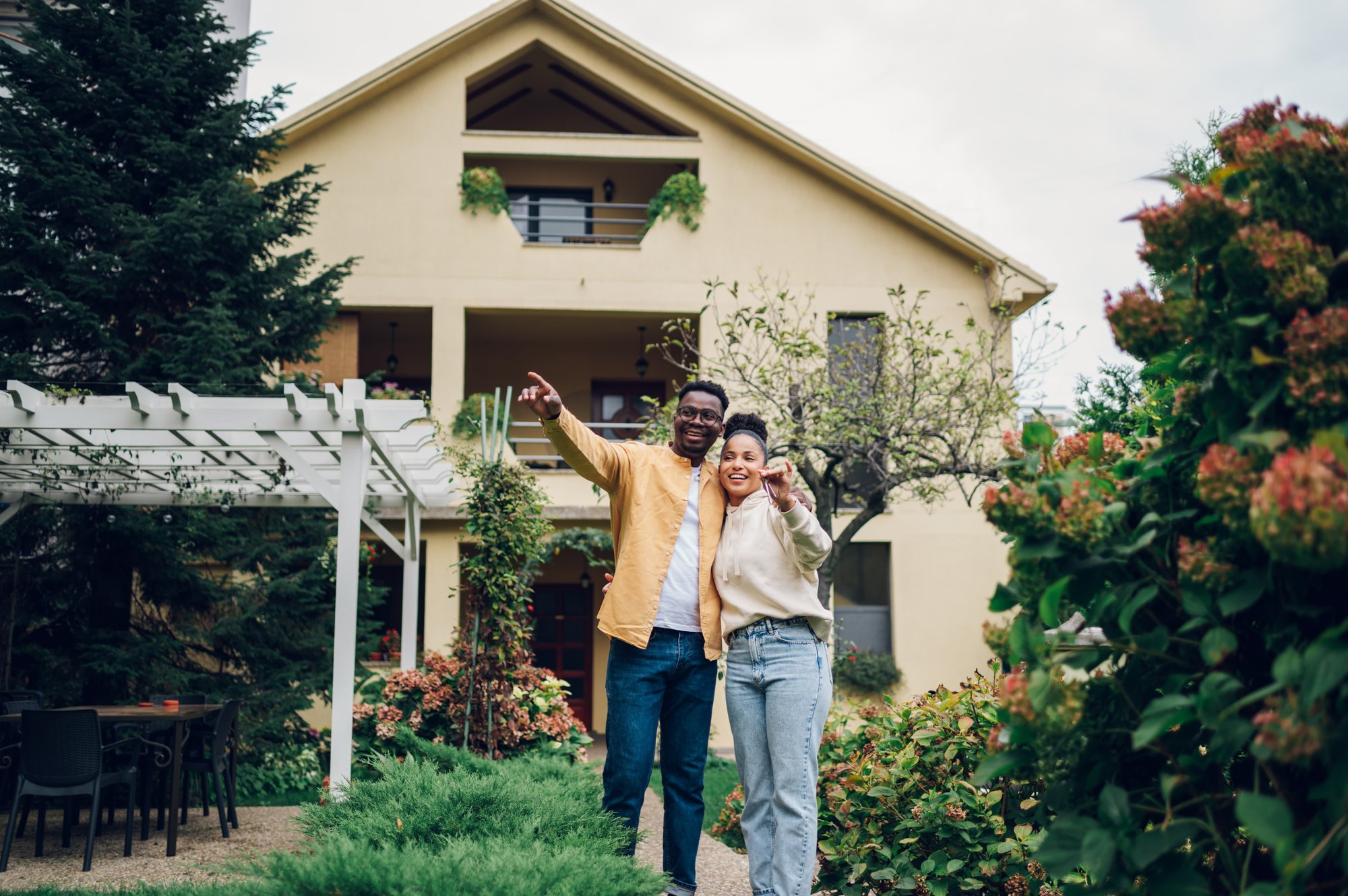 multiracial-couple-holding-keys-and-standing-outsi-2023-11-27-05-27-52-utc