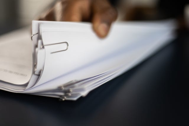 hand-flipping-through-paperwork hand-flipping-through-paperwork