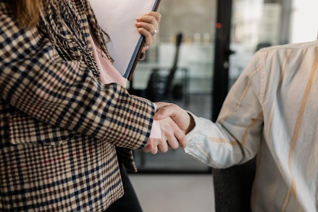 people-shaking-hands-with-documents people-shaking-hands-with-documents