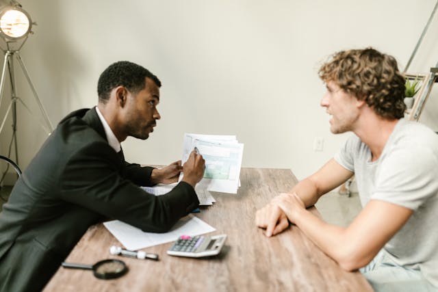 two-people-reviewing-paperwork two-people-reviewing-paperwork