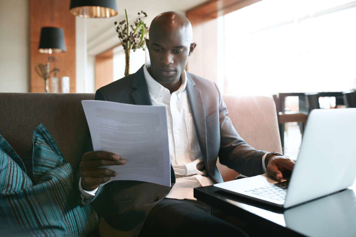 businessman_20sitting_20a_20hotel_20coffee_20shop_20reading_20a_20document businessman_20sitting_20a_20hotel_20coffee_20shop_20reading_20a_20document