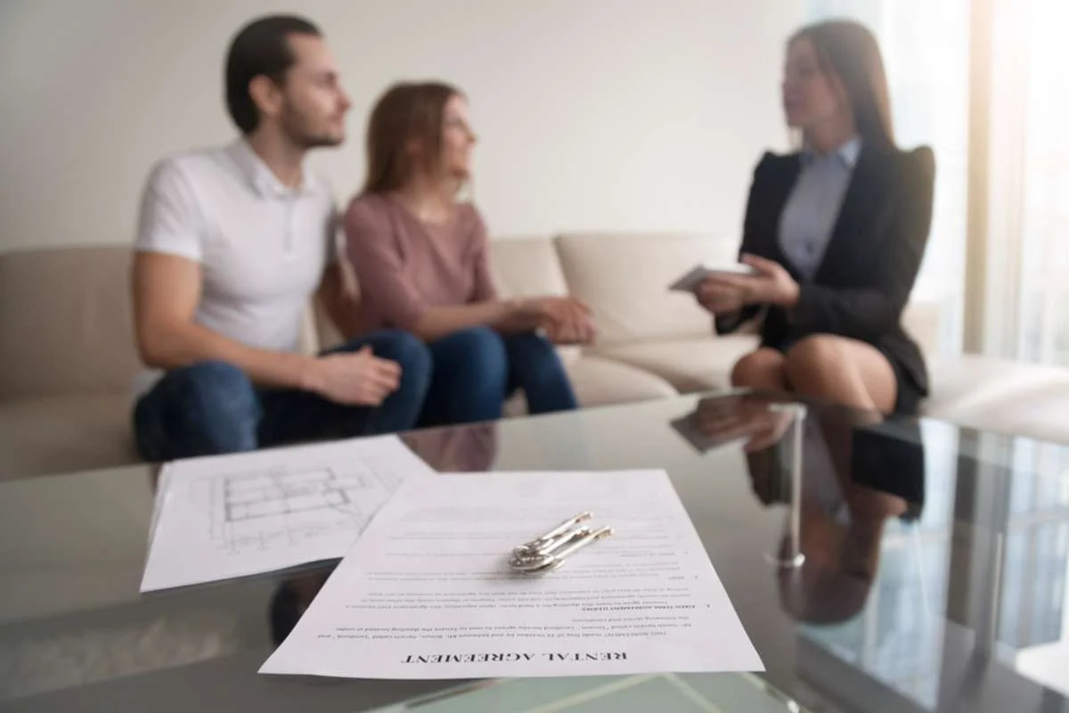 Young_20renters_20couple_20sitting_20on_20couch_20discussing_20renting_20apartment Young_20renters_20couple_20sitting_20on_20couch_20discussing_20renting_20apartment