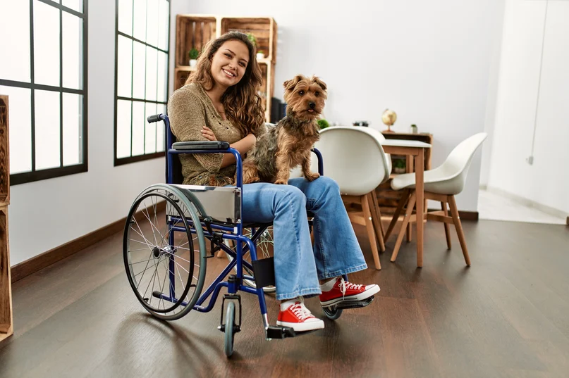 Young_20hispanic_20girl_20sitting_20on_20wheelchair_20at_20home_20smiling_20looking_20to_20the_20side_20and_20staring_20away_20thinking Young_20hispanic_20girl_20sitting_20on_20wheelchair_20at_20home_20smiling_20looking_20to_20the_20side_20and_20staring_20away_20thinking