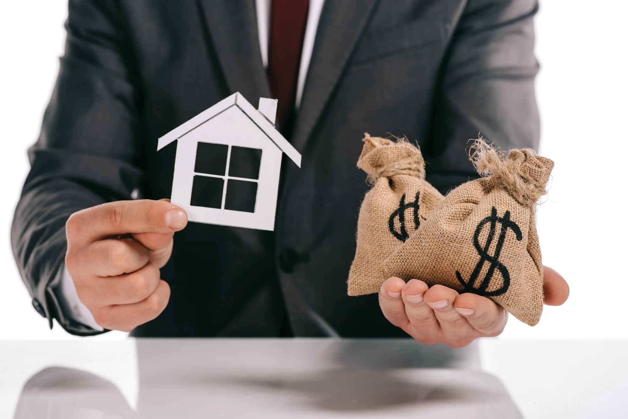 Cropped_20view_20of_20mortgage_20broker_20holding_20paper_20house_20and_20moneybags_20isolated_20on_20white Cropped_20view_20of_20mortgage_20broker_20holding_20paper_20house_20and_20moneybags_20isolated_20on_20white